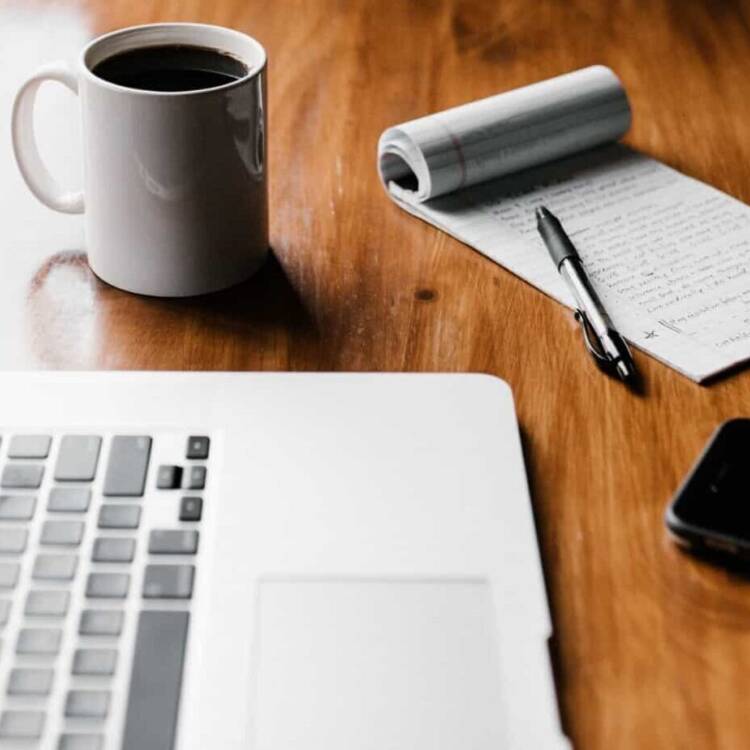Computer and coffee on a table